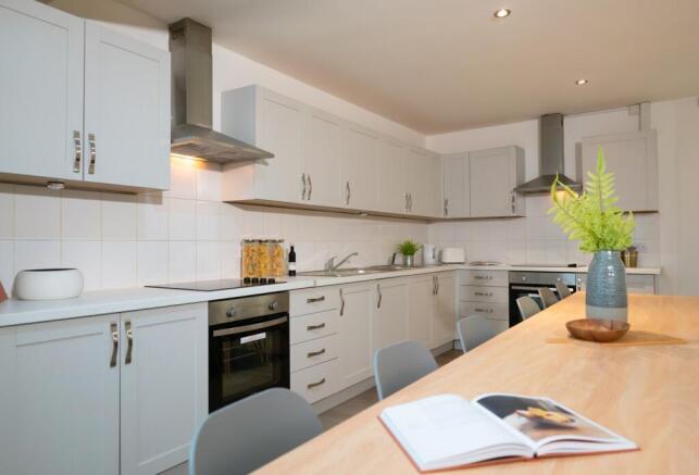 A modern and spacious kitchen with ample counte...
