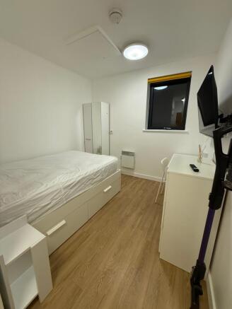 This inviting double bedroom features a comfort...