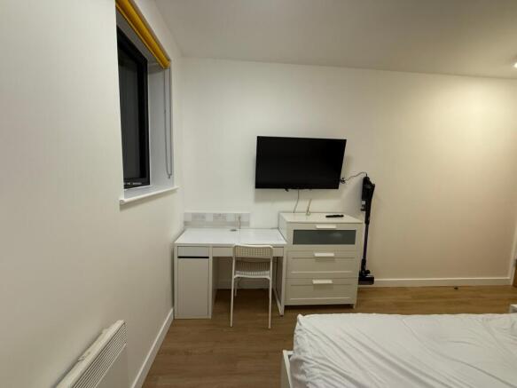 This inviting double bedroom features a comfort...
