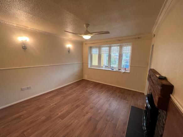 Bright and inviting living room featuring large...