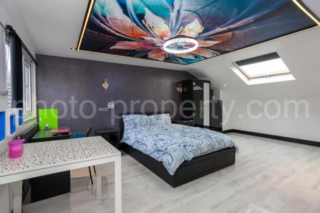 This spacious master bedroom features a stylish...