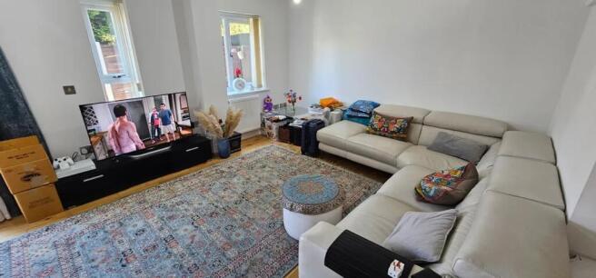 This spacious living room offers a cozy environ...