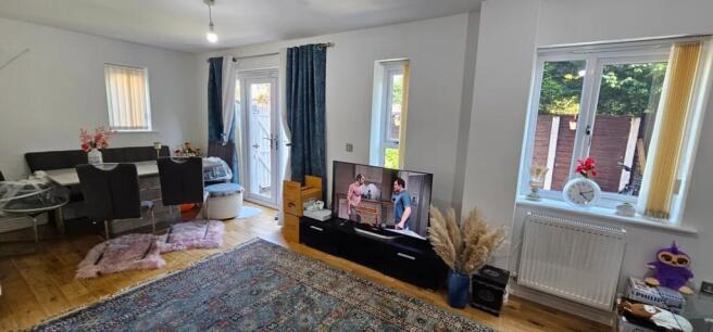 A bright and inviting living room featuring lar...