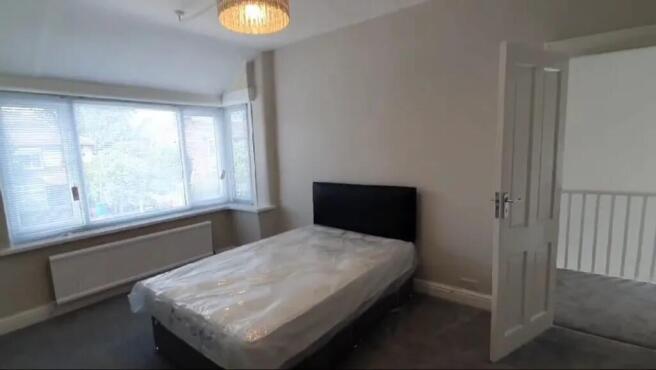 Bright and inviting double bedroom featuring am...