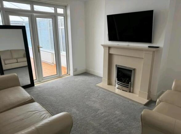 A bright and cozy living room featuring a styli...