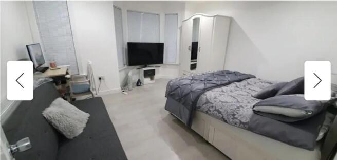 Spacious double bedroom featuring a comfortable...