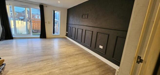 A spacious and modern living room with large wi...