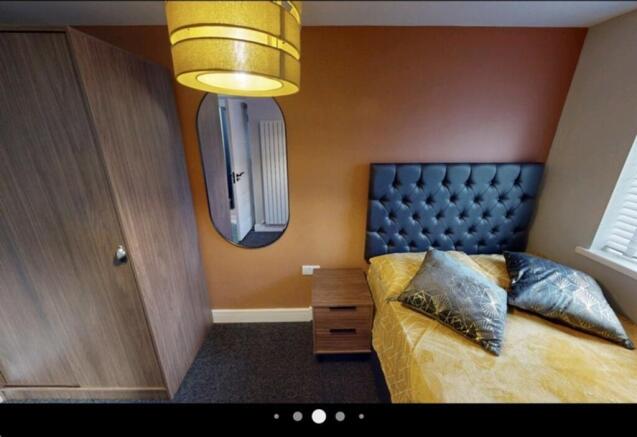 A cozy double bedroom featuring a stylish bed w...