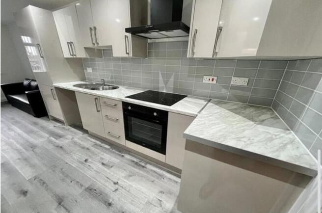 This modern kitchen features sleek cabinetry, s...