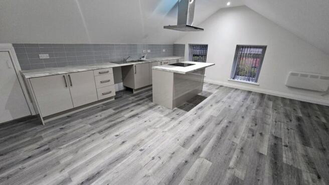 This modern kitchen features sleek cabinetry, a...