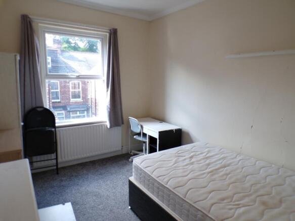 This charming double bedroom offers ample space...