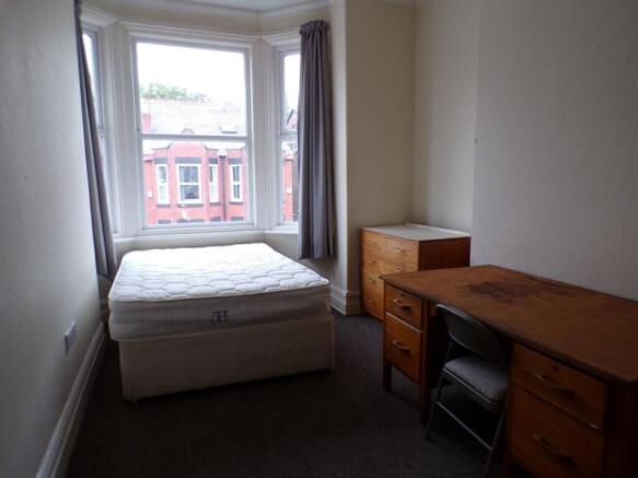Spacious double bedroom featuring large windows...