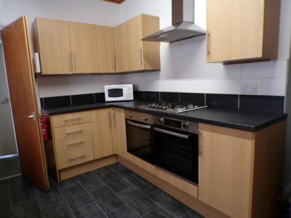 Spacious kitchen featuring modern appliances, a...