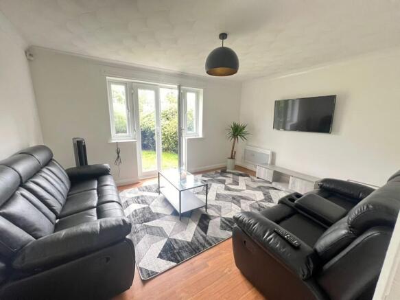 A spacious and inviting living room featuring m...