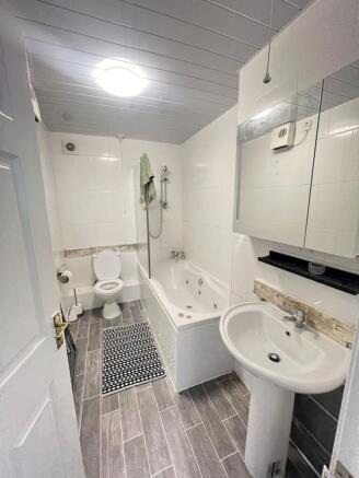 This well-appointed bathroom features a modern ...