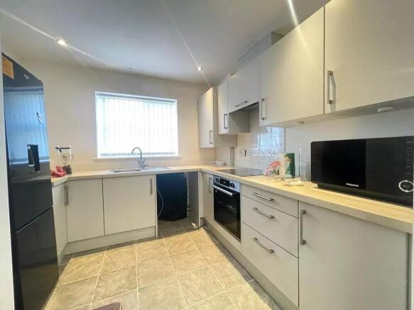 This modern kitchen boasts ample counter space ...