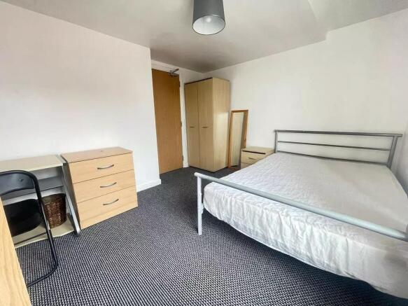 Spacious double bedroom featuring a comfortable...