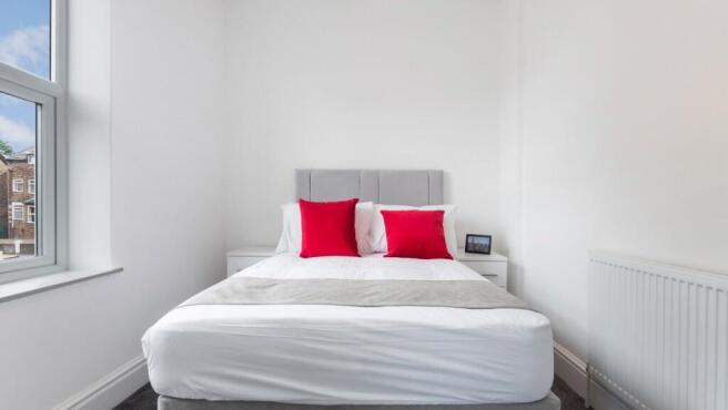 Bright and inviting double bedroom featuring el...