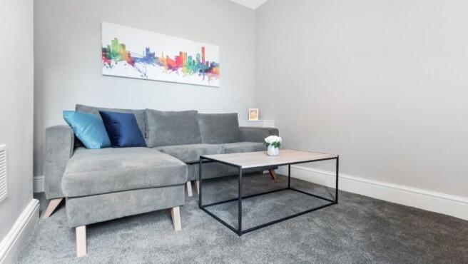 This cozy living room features a stylish grey s...