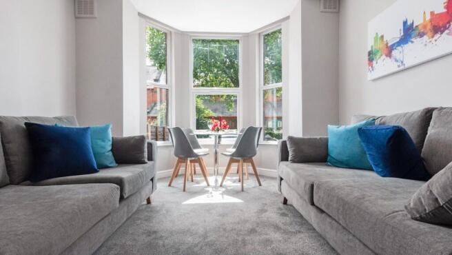 This inviting living room features ample natura...