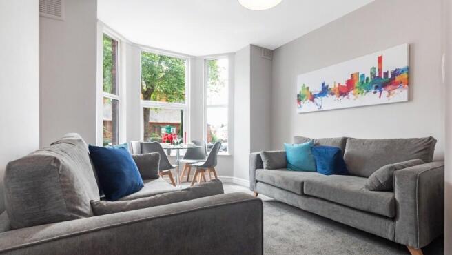 A bright and inviting living room featuring mod...