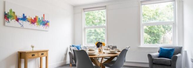Bright and inviting living room featuring large...