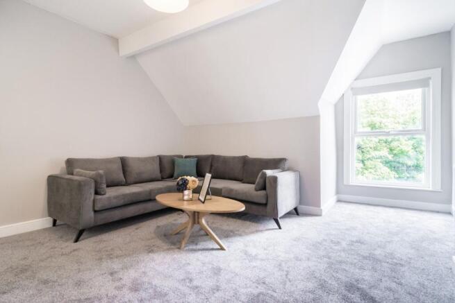 This inviting living room features a cozy gray ...