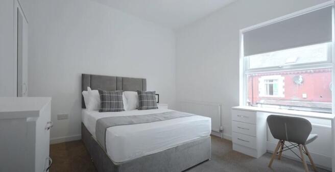 Bright and inviting double bedroom featuring a ...