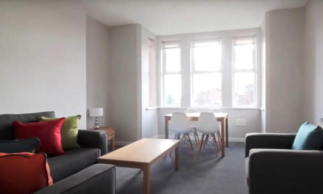 Bright and inviting living room with large wind...