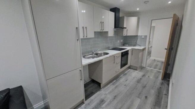 Modern galley kitchen featuring sleek cabinetry...