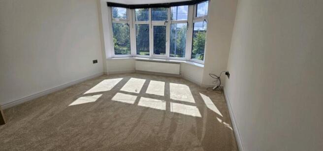 Bright and spacious double bedroom featuring la...