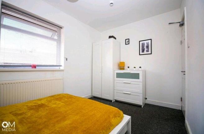 Bright and tidy bedroom featuring a comfortable...