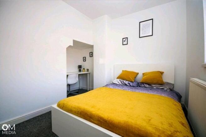 Bright and cozy double bedroom featuring a comf...