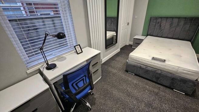 A modern double bedroom featuring a comfortable...