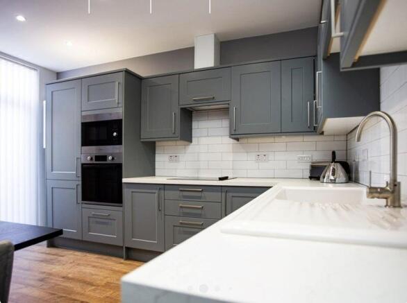 Contemporary kitchen featuring sleek grey cabin...