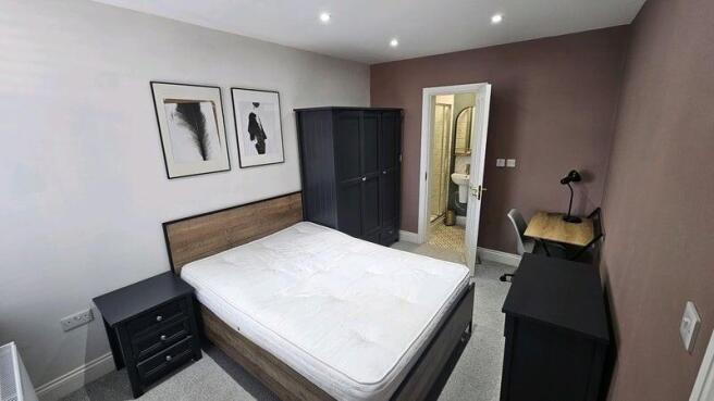 A modern master bedroom featuring a comfortable...