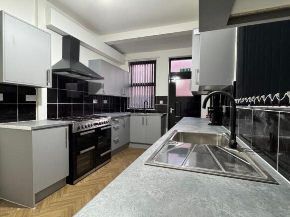 Bright and modern kitchen featuring sleek grey ...