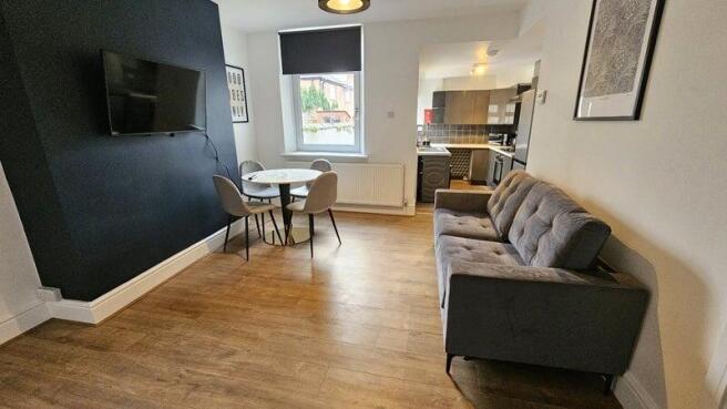 Bright and modern living room featuring a comfo...