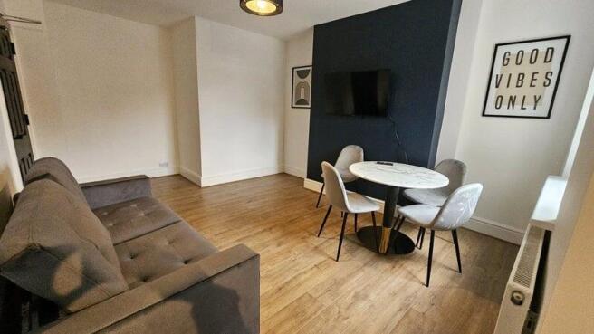 A modern living room featuring a comfortable gr...