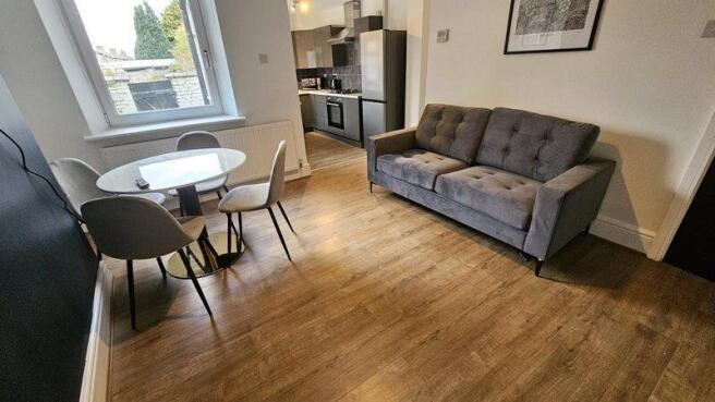 Modern living room featuring a comfortable grey...