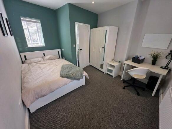 Bright and tidy double bedroom featuring a comf...