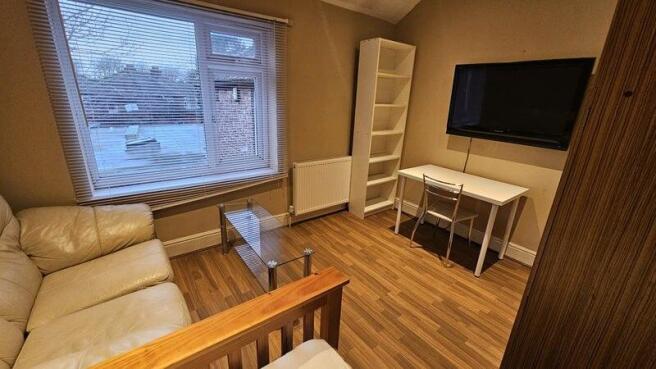 A cozy living room featuring a comfortable crea...