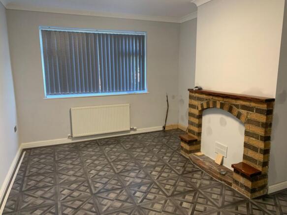 A clean and tidy living room featuring a decora...
