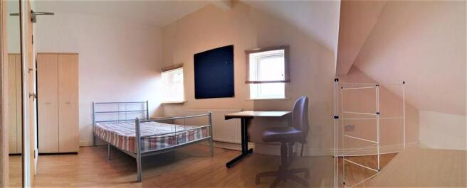 A spacious and bright master bedroom featuring ...