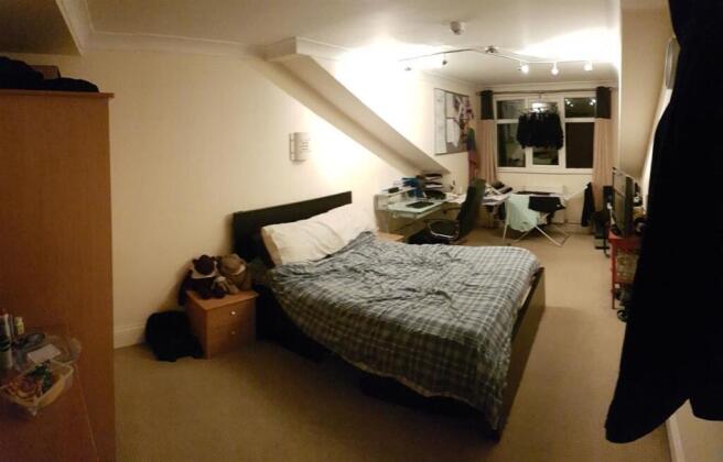 A cozy master bedroom featuring a double bed wi...