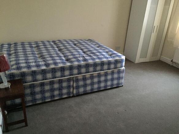 A tidy double bedroom featuring a comfortable b...