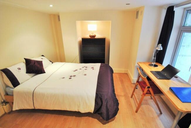 Bright and cozy double bedroom featuring a comf...