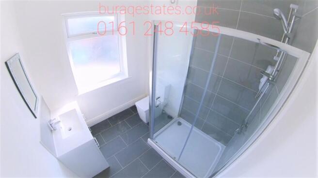 Bright and modern bathroom suite featuring a sp...