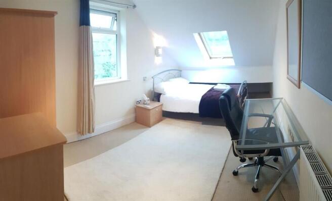 Bright and spacious master bedroom featuring a ...