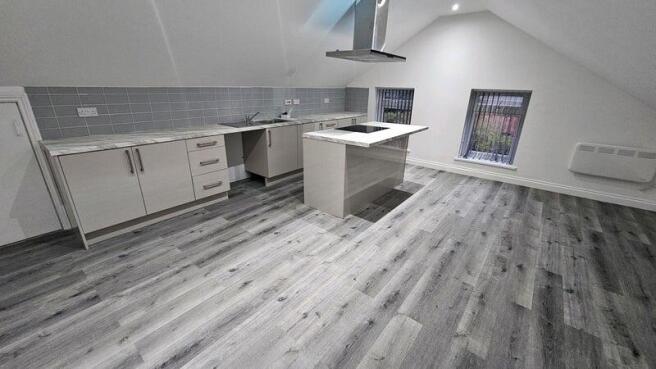 A modern kitchen with sleek cabinetry and a cen...